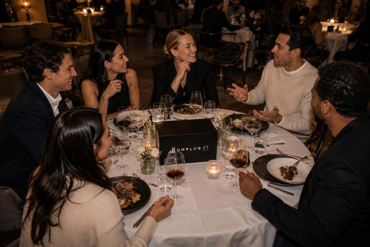 Six people at a premier venue UNPLUG dinner in conversation